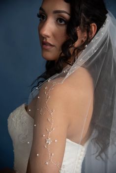 a woman in a wedding dress with a veil on her head