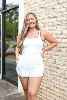 Our "On the Green Romper" is perfect for an outdoor event. It is white with green trim. This romper has an elastic waistband. Green Sporty Jumpsuits And Rompers For Summer, Sporty Green Jumpsuits And Rompers For Summer, White Sporty Jumpsuits And Rompers For Spring, Sporty White Sleeveless Jumpsuits And Rompers, White Sleeveless Sporty Jumpsuits And Rompers, White Sleeveless Sporty Jumpsuit, Casual Green Fitted Bubble Romper, Fitted Green Bubble Romper For Play, Playful Fitted Green Bubble Romper