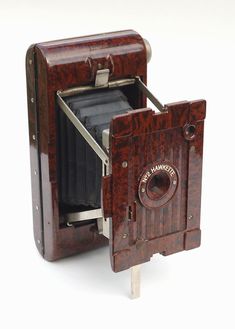 an old fashioned wooden camera on a white background