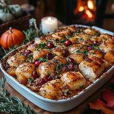 a casserole dish with potatoes and cranberries in it on a table