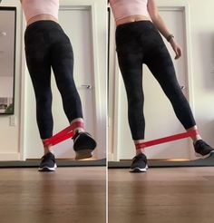 a woman in tight black pants holding a red tape around her waist while standing on top of a wooden floor