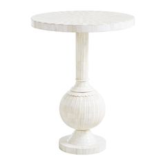 a white table with a circular base on the top and an intricate design at the bottom