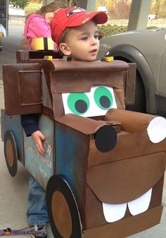 a young boy in a costume made to look like a truck