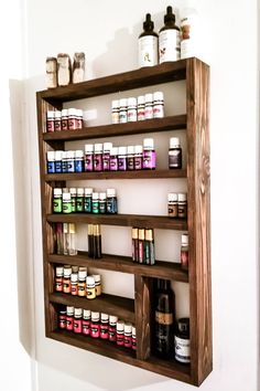 a wooden shelf filled with lots of different types of medicine bottles on top of it