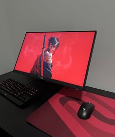 a computer monitor sitting on top of a desk next to a keyboard and mouse,