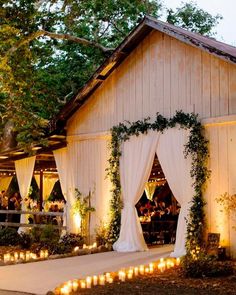 an outdoor wedding venue with candles lit up