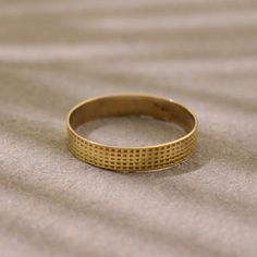 a gold ring sitting on top of a bed