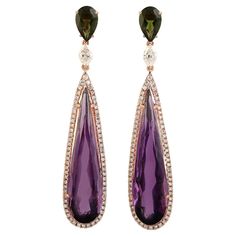 Hand cast from 14-karat gold, these stunning earrings are set with 15.78 carats amethyst. 1.45 carats tourmaline and 1.0 carats of sparkling diamonds. FOLLOW MEGHNA JEWELS storefront to view the latest collection & exclusive pieces. Meghna Jewels is proudly rated as a Top Seller on 1stDibs with 5 star customer reviews. All items manufactured by us are handmade and can be customized or redesigned. Composition Size-50X10 MM Total Weight-9.295 Gold Weight(Gms)-5.65 Diamond Wt(Cts)-1.0 Amethyst Wt(C Amethyst Gold, Top Seller, Stunning Earrings, Hand Cast, Modern Earrings, Gold Jewelry Fashion, Sparkle Diamonds, Chandelier Earrings, Modern Jewelry