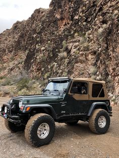 a jeep parked in front of a mountain