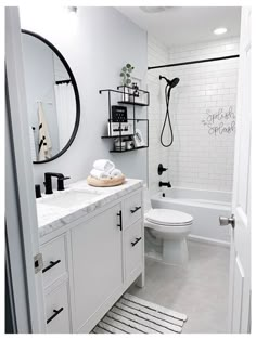 a white bathroom with black and white accessories