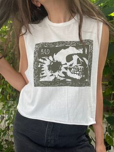 Screenprint adapted from an original painting of a skull with a sunflower. Printed in hand mixed green ink on a lightweight white cropped tank top. Size Medium Alternative Style Skull Print Tops For Summer, White Custom Print Grunge Tops, White Grunge Style Top With Custom Print, Punk Style Screen Print Tops For Summer, Punk Style Summer Tops With Screen Print, Alternative Acid Wash Top With Screen Print, Graffiti Print Tops For Summer Alternative Fashion, Graffiti Print Tops For Alternative Summer Fashion, Summer Punk Style Screen Printed Tops