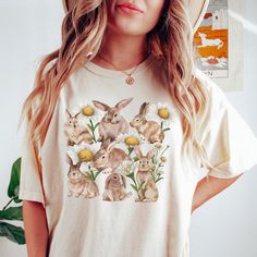 Get ready to fall in LOVE with your new floral, daisy, and rabbit design comfort colors t-shirt. It's the cutest and most comfortable way to wear the latest styles, and also makes a great gift! * PRODUCT DETAILS * ✺ 100% Cotton ✺ Medium weight fabric  ✺ Wash and dry normally (on cool for best results) ✺ Designed and printed in the USA ✺ Due to different monitor screens, colors may vary ✺ * SIZING * ✺ FOR AN OVERSIZED FIT, SELECT TWO OR THREE SIZES UP FROM YOUR NORMAL SIZE ✺ ✺ Sizing is unisex ✺ Casual T-shirt With Bunny Design And Crew Neck, Casual Cotton T-shirt With Bunny Print, Casual Crew Neck T-shirt With Bunny Design, Summer Cotton Tops With Bunny Design, Summer Cotton Top With Bunny Design, Spring Bunny Design Short Sleeve Top, Spring Crew Neck Tops With Bunny Design, Spring Cotton T-shirt With Bunny Design, Casual Bunny Design T-shirt For Spring