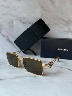 Brand new Prada PR A52S 15N01T Sunglasses in Gold.Featuring a gold metal frame with brown lenses.Black and gold metal Prada logos on temples.Size 56-17-140.100% authentic and unworn.Made in Italy.Box, case, cloth and paperwork included. Retail $503. Luxury Gold Rectangular Sunglasses, Modern Gold Shield Sunglasses With Metal Frame, Modern Gold Aviator Sunglasses With Tinted Lenses, Modern Gold Shield Sunglasses With Tinted Lenses, Modern Gold Tinted Shield Sunglasses, Formal Gold Tinted Sunglasses, Luxury Gold Polarized Sunglasses, Luxury Gold Sunglasses With Metal Frame, Luxury Gold Shield Sunglasses With Uv Protection