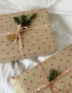 two wrapped presents are sitting on a bed