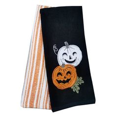 two towels with pumpkins on them and one has a jack - o'- lantern