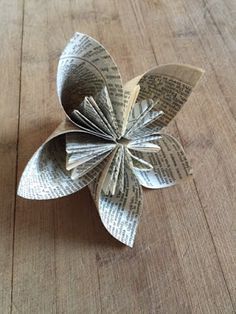 an origami flower on a wooden table