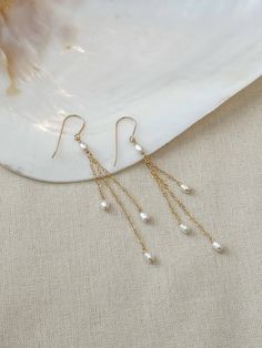 These delicate genuine pearl earrings add an elegant hint of shimmer to your special occasion look! The dainty and minimalist style is made with all sensitive skin safe materials.  * 14K Gold Filled or 925 Sterling Silver ear wire and accents * 3.5 inch length * Genuine Freshwater Pearls * Made with all hypoallergenic materials 🤍 *Please note for the health and safety of my customers, and to uphold the highest quality standards - these earrings are final sale - please dm me with any questions prior to purchase 😊 ✨  Shop all Pearl earrings here!: https://etsy.me/3Xiy4c5 GET TO KNOW MAGBEE JEWELRY! ✨  🤍 All MagBee pieces are safe for sensitive skin and made with hypoallergenic Gold Filled or 925 Sterling Silver. 🤍 I only use real/natural gemstones and Pearls. 🤍 Most items are made to or