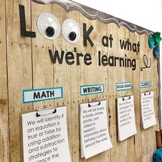 a bulletin board that has been decorated with magnets and eyeballs on the wall