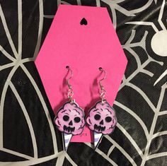 Handmade earrings with double sided charms of a skull cotton candy. Made on stainless steel earring hooks.  Ships within one week of purchase. Free gift on orders over $10, free shipping on orders over $35, and two free gifts on orders over $50! Pink Dangle Jewelry For Halloween, Pink Punk Halloween Jewelry, Pink Skull Jewelry For Halloween, Quirky Pink Earrings, Pink Halloween Party Earrings, Info Ships, Candy Earrings, Ghost Earrings, Skull Face