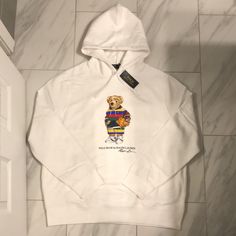 Men’s Polo Ralph Lauren Polo Bear Hoodie Price Is Firm At $130. Color: White Condition: 10/10 New W Tags White Hoodie With Embroidered Logo Long Sleeve, White Hoodie With Embroidered Logo, White Sporty Hoodie With Embroidered Logo, Sporty White Hoodie With Embroidered Logo, White Long Sleeve Hoodie With Embroidered Logo, White Hoodie With Embroidered Logo For Winter, Winter White Hoodie With Embroidered Logo, Ralph Lauren Shirts Men, Polo Bear Hoodie