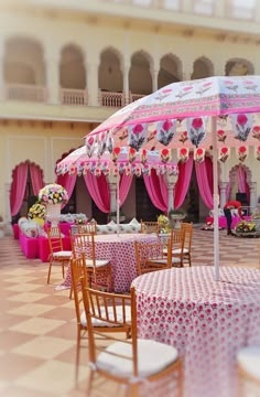 tables and chairs are set up under umbrellas for an outdoor wedding reception at the palace