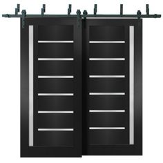 two black doors with bars on each side and one closed, the other closed up