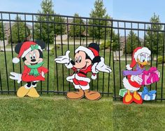 three cartoon characters are standing in front of a fence, one is dressed as mickey mouse