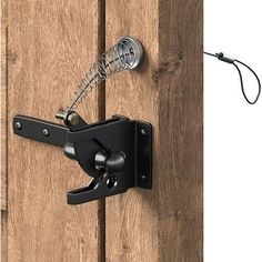 a door handle is attached to the side of a wooden door with a hook on it