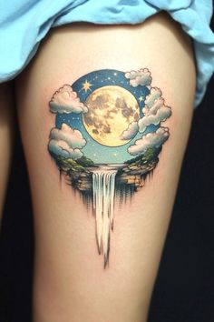 a woman's thigh with an image of a waterfall and the moon in the sky