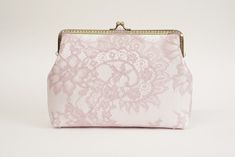 a pink lace purse on a white background