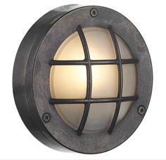 a light that is on the side of a wall with an iron caged design