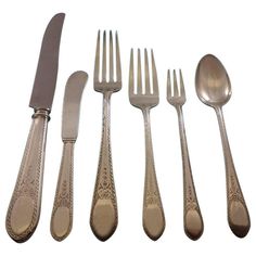 an assortment of silverware including forks, knives and spoons on a white background