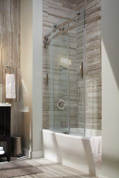 a bathroom with a bathtub, sink and towel rack