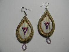 two pairs of earrings with beaded designs on them