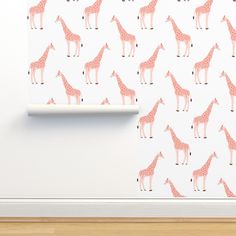 pink giraffes on white wallpaper in an empty room