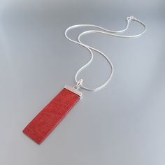 Mens silver chain pendant necklace Red Coral gemstone, Handmade jewelry for men, Unique gifts for men Gnatus all-stone Pendant with natural red Coral and sterling silver hook. The unique long rectangle shape and the natural red/orange color, adds a unique mat spark and gives a modern touch to this pendant. It is thoughtfully set into 925 Sterling silver and a 10mm hook is placed on the upper part of the pendant for perfect balance. Modern design for Men and perfect gift for him. The Pendant feat Modern Red Necklace Perfect As A Gift, Minimalist Red Pendant Necklace, Red Minimalist Pendant Necklace, Modern Red Necklace For Gift, Handmade Red Necklace With Rectangular Pendant, Mens Necklace Pendant, Silver Chain For Men, Unique Gifts For Men, Mens Pendant