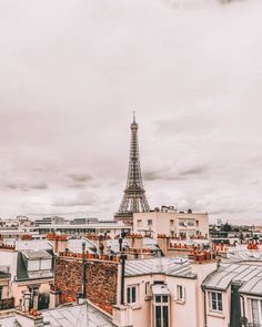 the eiffel tower in paris is seen from above, with rooftops and windows