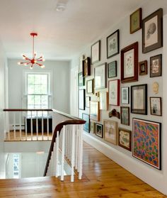 a staircase with many framed pictures on the wall