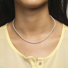 This elegant 4-Prong Tennis Necklace will be sure to add a touch of class to any outfit. Crafted with diamond-like 4-prong stones, this statement piece is sure to shine. With premium quality metal and an understated luminance, this necklace is a timeless piece perfect for both day and night. Dazzling Diamond-cut Tennis Necklace, Crystal Tennis Necklace With Diamond Cut, Fine Jewelry Diamond Accents Tennis Necklace, Diamond White Rhinestone Necklace With Diamond Accents, Brilliant Cut Necklace For Formal Occasions, Diamond White Tennis Necklace With Prong Setting, Anniversary Rhinestone Necklace With Diamond Accents, Minimalist Tennis Necklace For Anniversary, Diamond White Solitaire Necklace For Formal Occasions