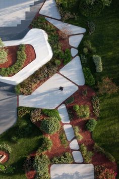 an aerial view of a house with trees and grass