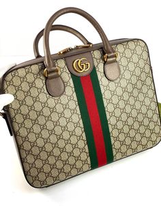 The briefcase featured in the Ophidia range is crafted in GG Supreme canvas, paired with a signature combination of House Web fabric and Double G hardware. The double-handled model also features a detachable shoulder strap so it can be carried over the shoulder. A secure zip closure and a large internal open pocket complete the silhouette. Gg Collection, Men's Briefcase, Gucci Ophidia, Briefcase For Men, Handbag Wallet, How To Make Handbags, Diaper Backpack, Branded Handbags, Gucci Men