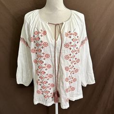 Nwt Mystree Embroidered Tunic Top Medium Tassel Ties 100% Cotton Gauze Material Ivory Top With Coral Embroidery Underarm To Underarm 21.5 Inches Length 26 Inches White Cotton Top With Back Tassel Tie-up, White Cotton Top With Tassels, Spring Folk Style Tops With Tassels, White Bohemian Blouse With Back Tassel Tie-up, Folk Style Tops With Tassels For Spring, Folk Style Tassel Tops For Spring, Red Tassel Tops For Beach, White Cotton Tops With Back Tassel Tie-up, Traditional Spring Blouse With Tassels