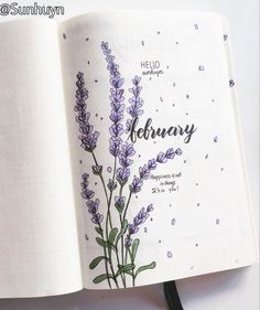 an open book with purple flowers on the cover and writing in black ink, sitting on top of a white surface