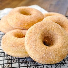 three donuts sitting on top of a cooling rack