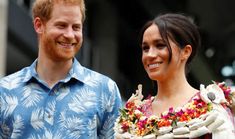 prince harry and his wife are smiling for the camera