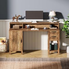 a wooden desk with a laptop on top of it next to a potted plant