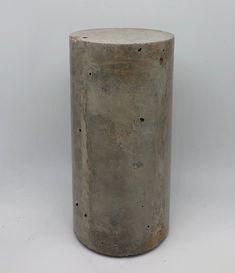 a concrete vase sitting on top of a white table