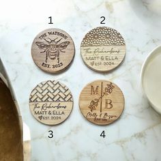 four wooden coasters with different designs on them