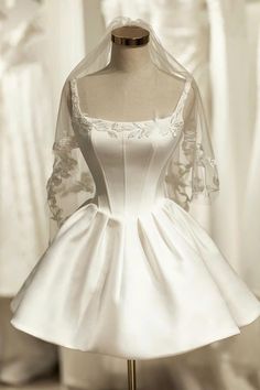 a white wedding dress on a mannequin