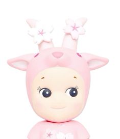 a pink toy with white stars on it's head and ears, sitting in front of a white background